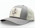 brown and khaki cap with a cowgirl riding a rooster and cowboy patch 