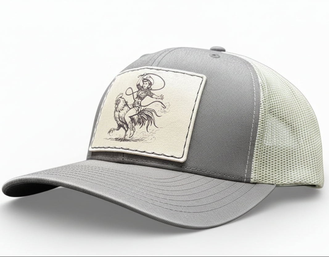 brown and khaki cap with a cowgirl riding a rooster and cowboy patch 