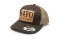 A brown leather hat with a patch on the front that reads 'FAFO' and the phrase 'Fuck Around & Find Out' on it.