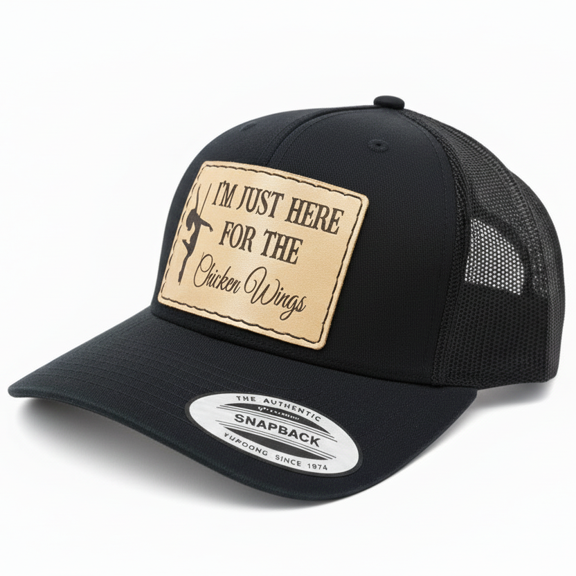 Black and white cap with a patch reading 'I'm just here for the chicken wings' on a white background