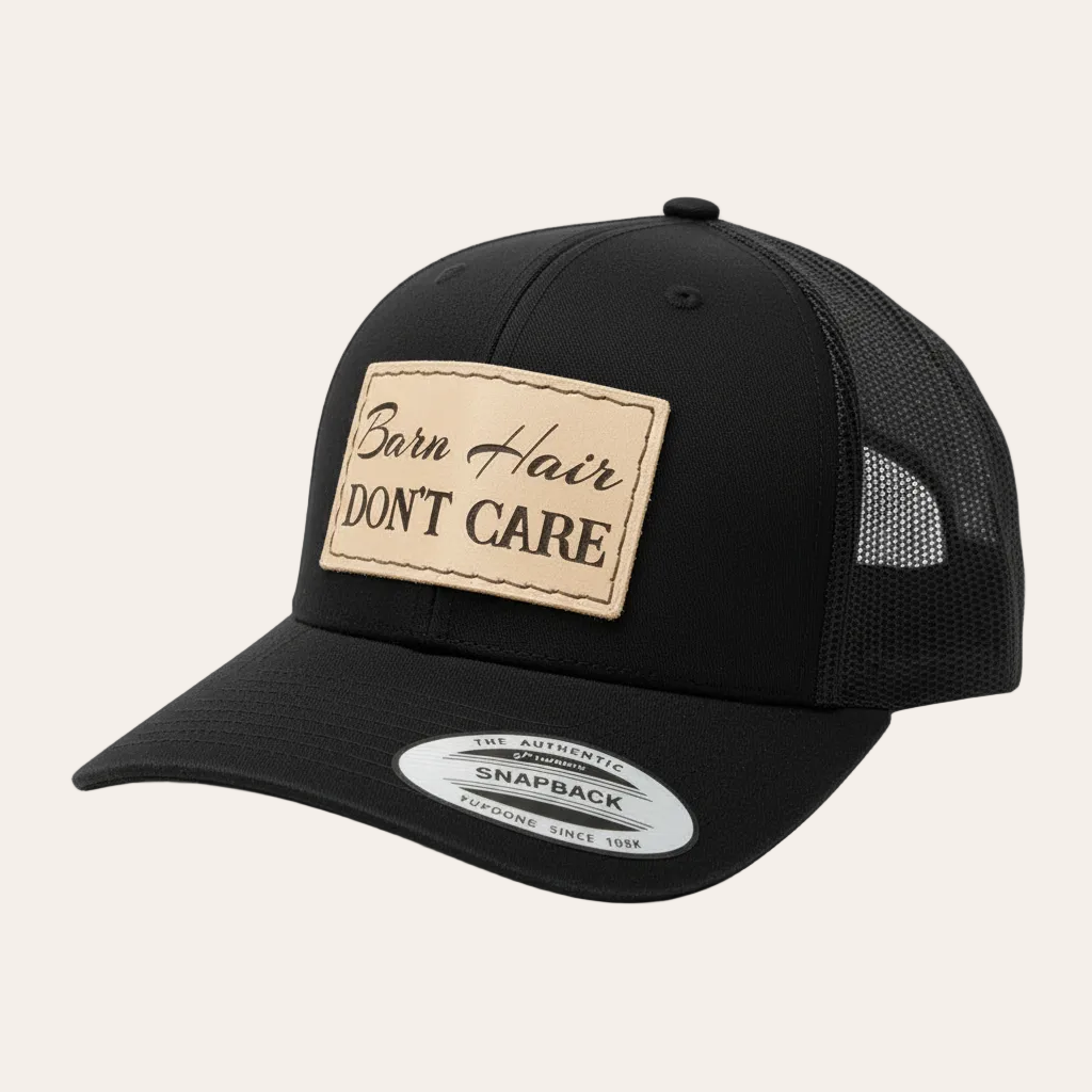Black trucker cap with 'Barn Hair Don't Care' patch on a white background