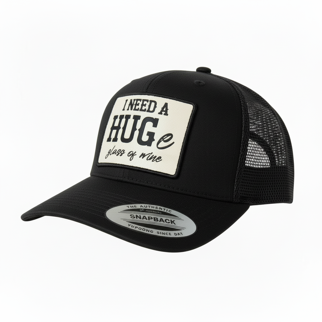 Brown and beige cap with a patch saying 'I need a HUGE glass of wine' on a white background