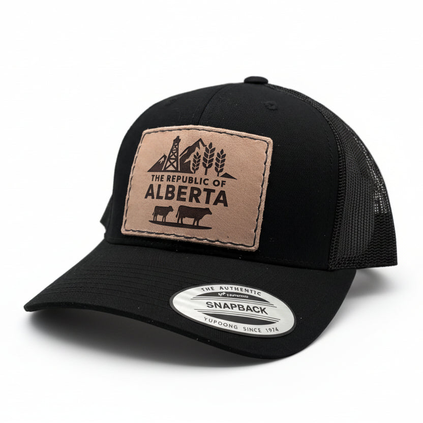 Black trucker cap with a tan patch featuring 'The Republic of Alberta' design on a white background.