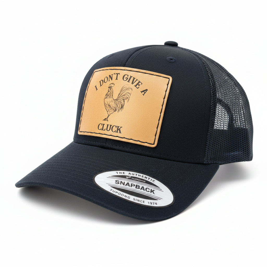 Black cap with a rooster patch and text on a brown textured background