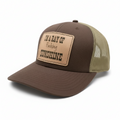 Brown and beige cap with a leather patch on a white background