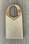 Brown leather pouch with a stone on a speckled gray surface