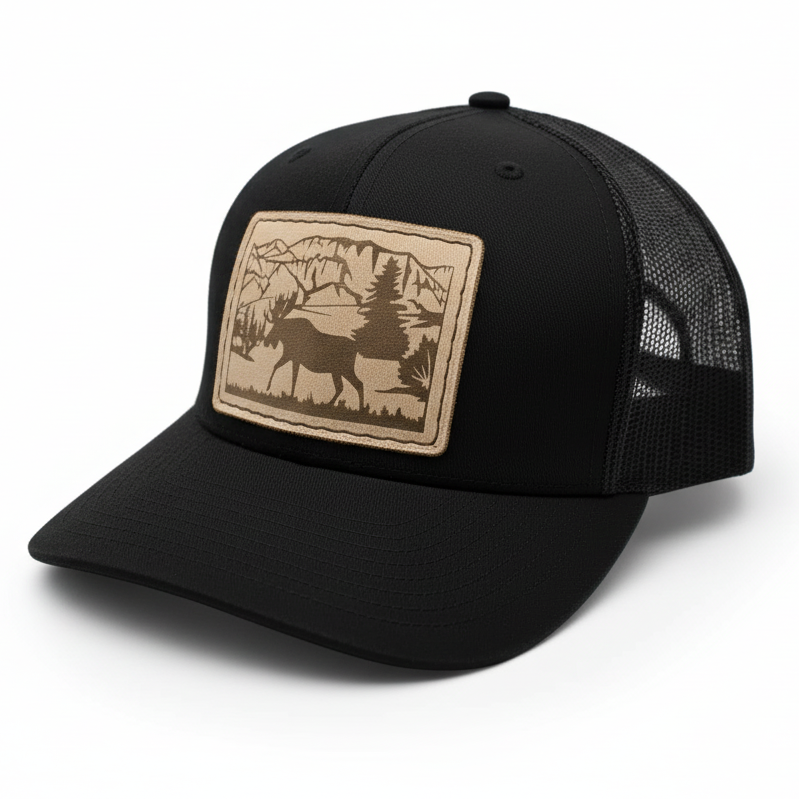 Black trucker cap with a nature-themed patch on a white background