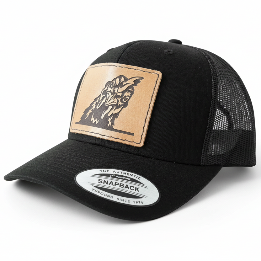 Black trucker cap with a leather patch featuring a chicken design on a white background