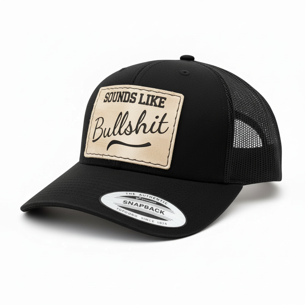 Black snapback cap with a beige patch and text on a white background
