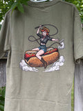 Green t-shirt with a graphic design of a woman on a hot dog against a wooden fence background